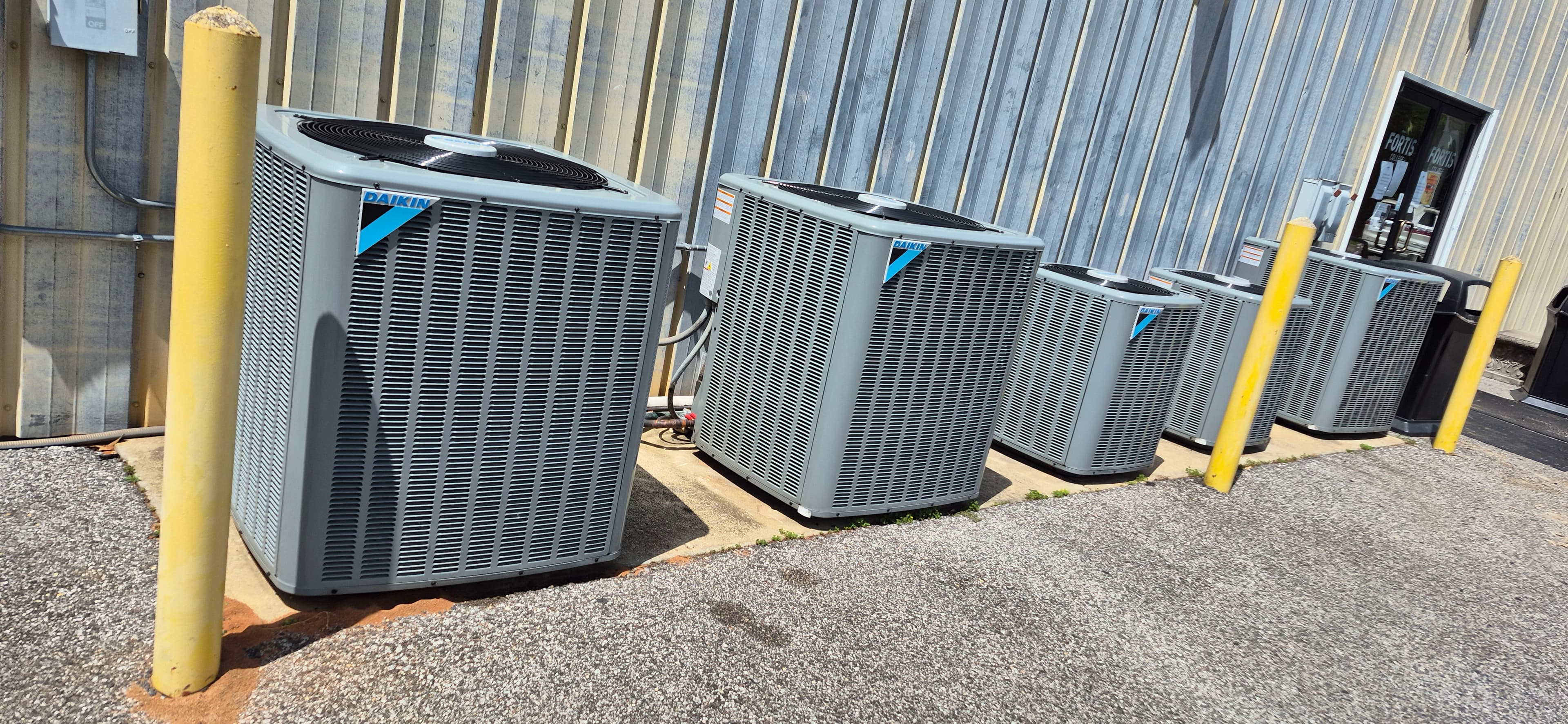 Row of newly installed outdoor condensing units