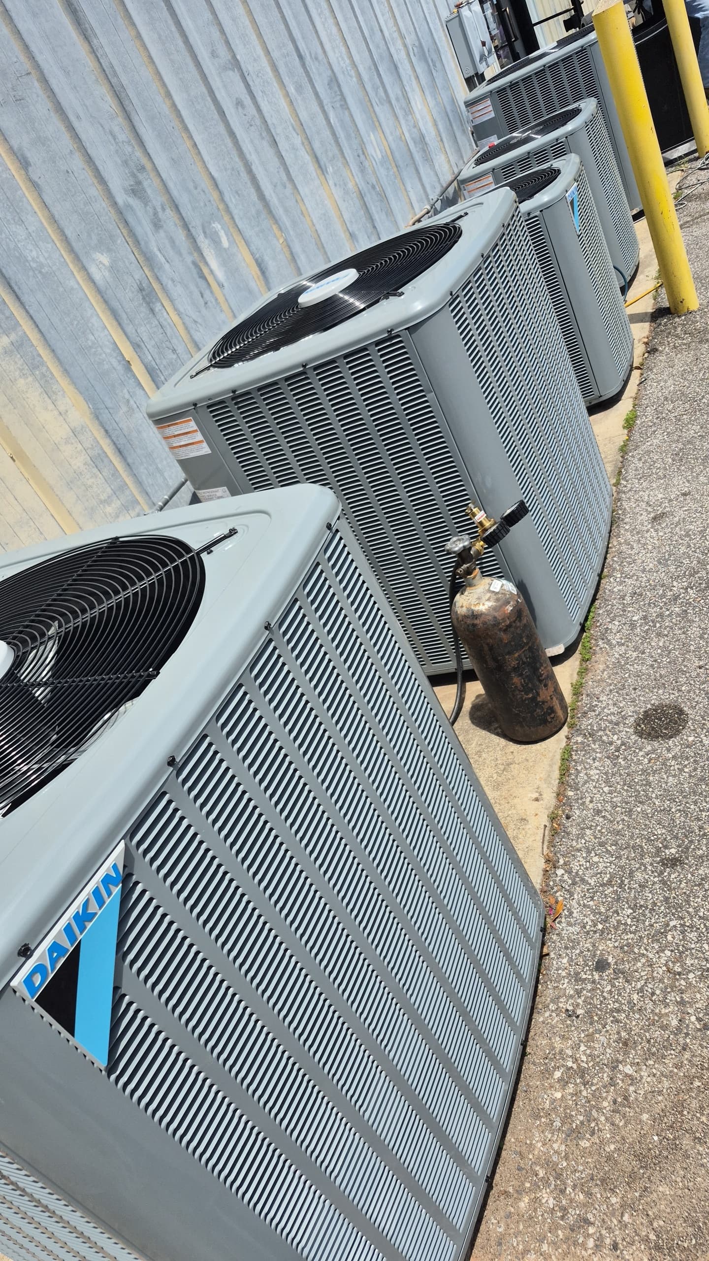 Multiple outdoor condensing units installed along an exterior wall